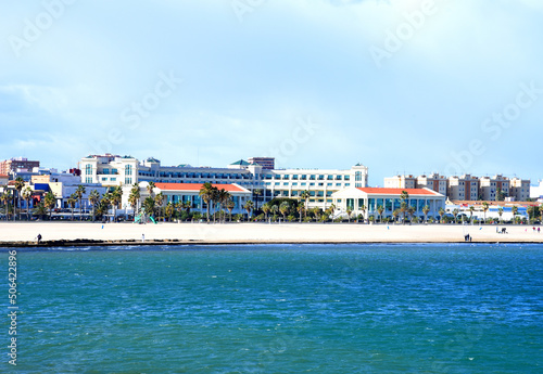 Coastline and beach at Mediterranean sea. View on coastline and beach from La Marina de Valencia on the sea to the Las Arenas beach. Waves at sea on sunset. Hotel Las Arenas on sunset.