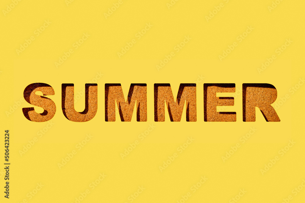 word summer cut out on a yellow paper