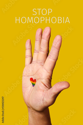 raised hand and text stop homophobia photo