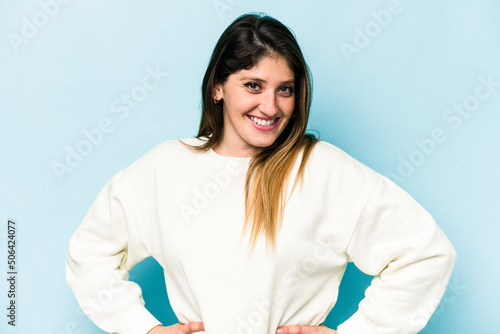 Young caucasian woman isolated on blue background happy, smiling and cheerful. © Asier