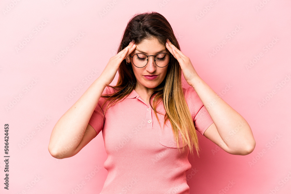 Young caucasian woman isolated on pink background touching temples and having headache. Young caucasian woman isolated on pink background touching temples and having headache.