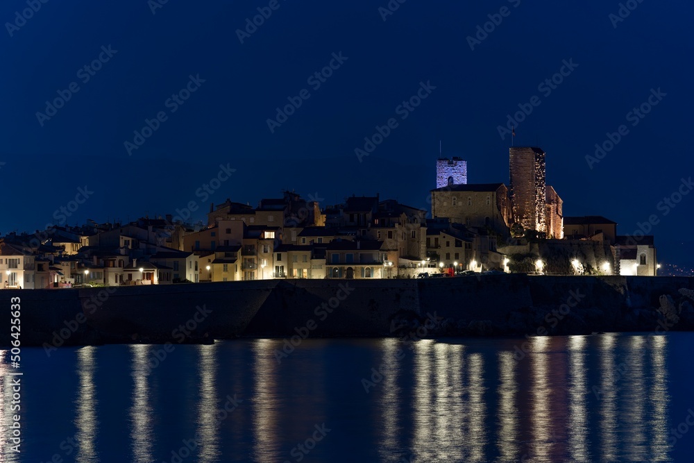 View of sea port in Cannes,France and its old town at night