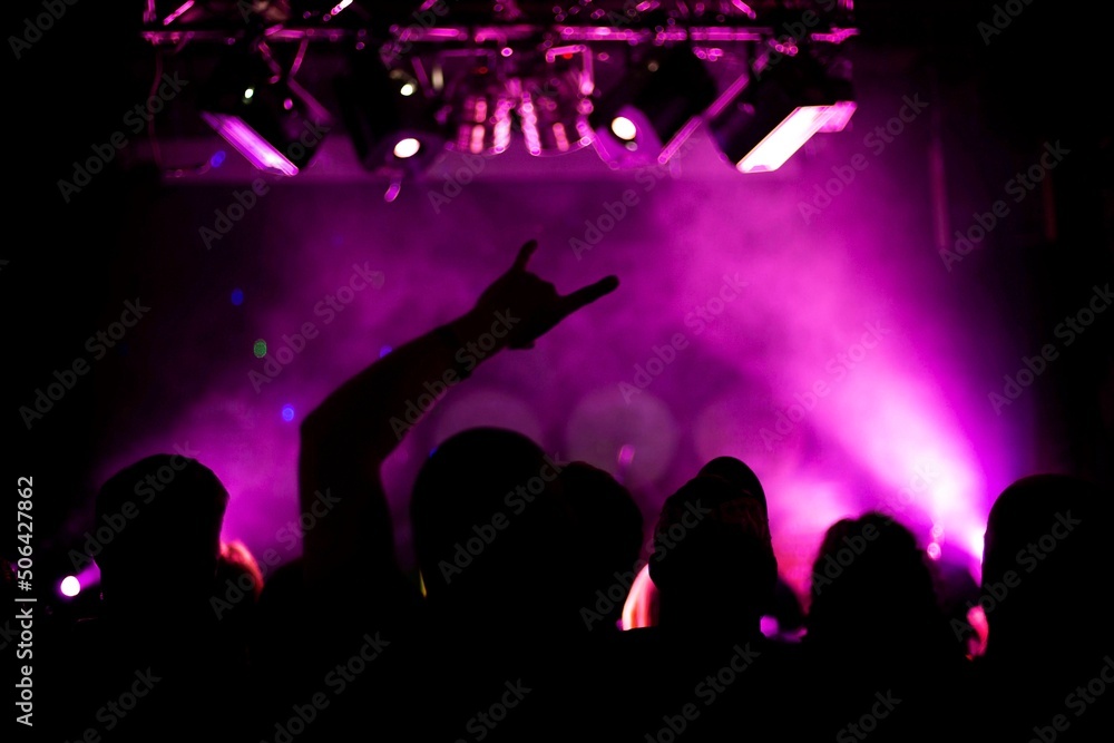 raised hands of crazy people at a rock concert, front and back background is blurred with bokeh effect raised hands of crazy people at a rock concert, front and back background is blurred with bokeh effect