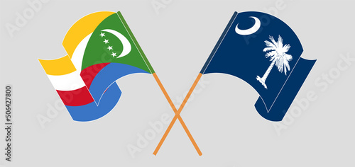 Crossed and waving flags of Comoros and The State of South Carolina