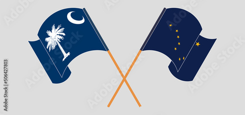 Crossed and waving flags of The State of South Carolina and the State of Alaska