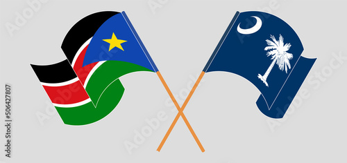 Crossed and waving flags of South Sudan and The State of South Carolina