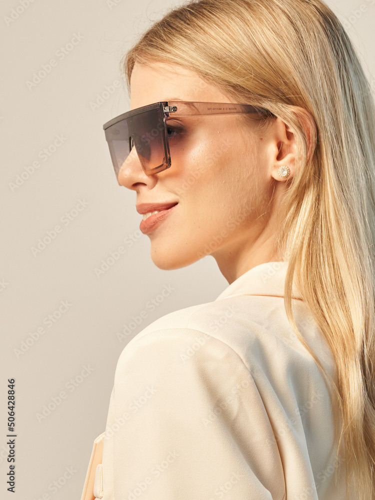 a beautiful young woman in a beret, a white jacket and sunglasses on a white background a beautiful young woman in a beret, a white jacket and sunglasses on a white background