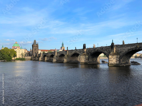 A medieval stone bridge spans the wide river