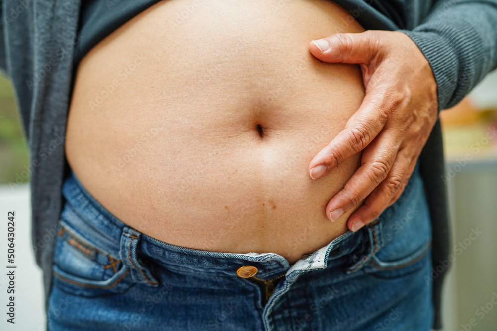 asian-woman-show-fat-belly-big-size-overweight-and-obesity-at-office