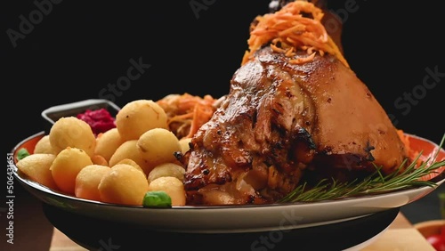 Baked pork knuckle with potatoes and cabbage