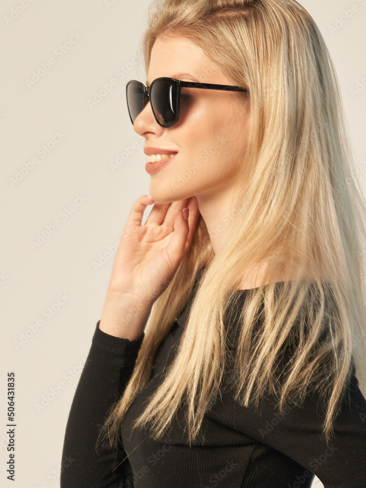 fashionable portrait of a beautiful blonde in dark glasses on a white background and in a dark shirt fashionable portrait of a beautiful blonde in dark glasses on a white background and in a dark shirt
