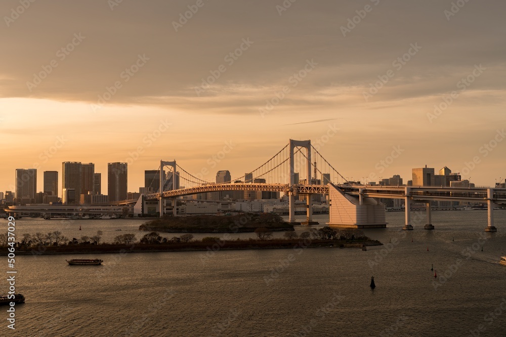 Fototapeta premium The Rainbow Bridge neighborhood in Tokyo Japan at Sunset