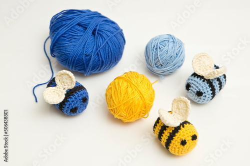 Blue and yellow crocheted bees and thread with crochet. DIY home made hand made baby rattle toy safe for toddlers.