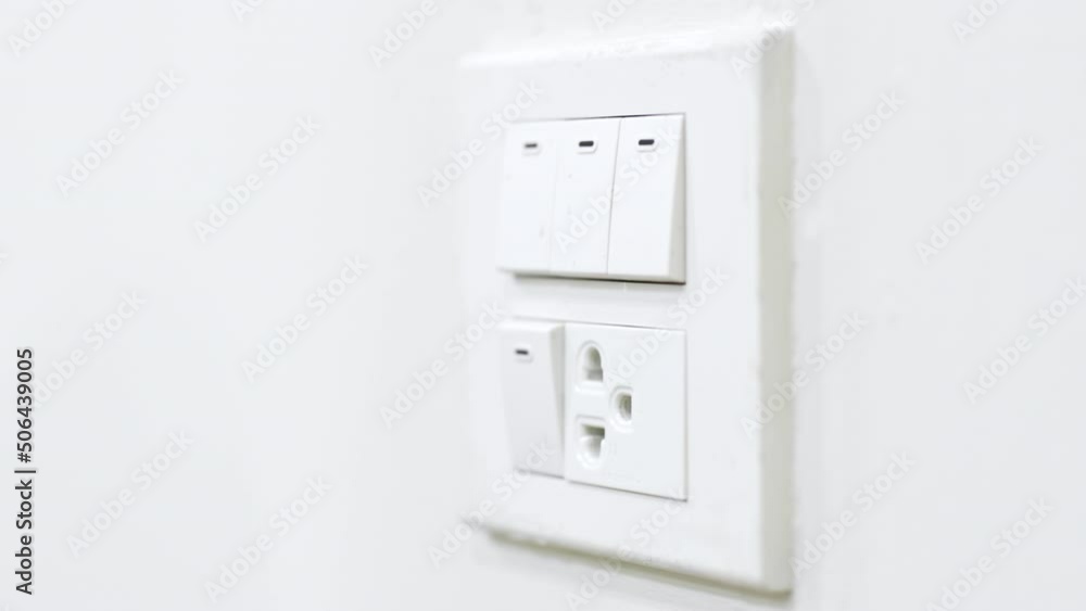 Closeup hand pull plug out from socket. Energy saving concept Closeup hand pull plug out from socket. Energy saving concept