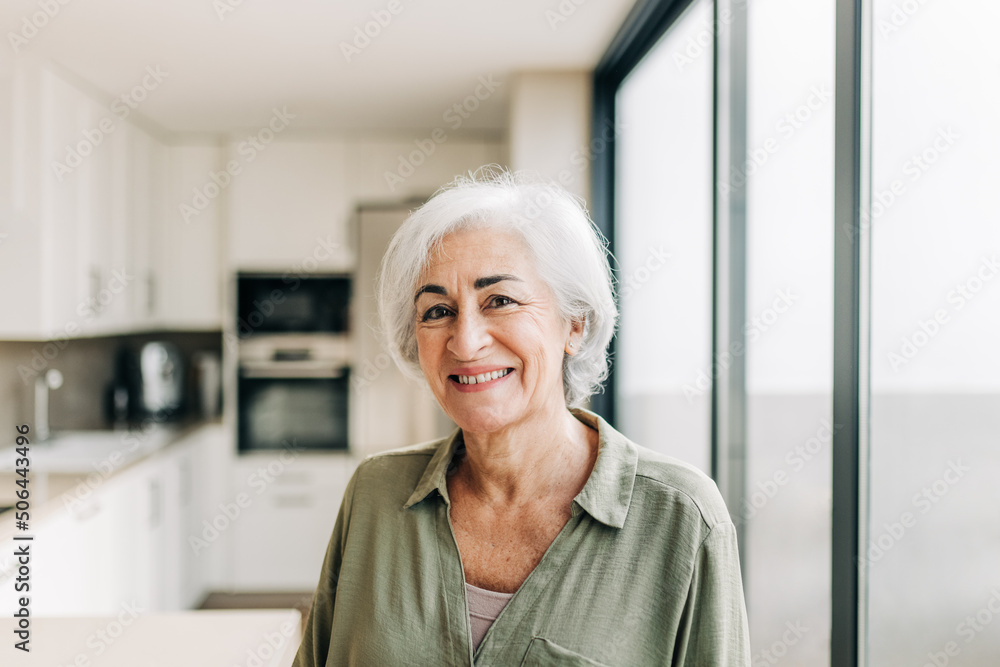 Happy elderly woman smiling cheerfully in her home Happy elderly woman smiling cheerfully in her home