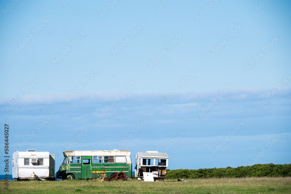 Old abandoned caravans and bus on farmland Old abandoned caravans and bus on farmland