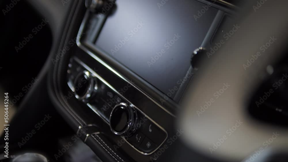 Interior of a new luxury premium car. Close-up of car doors, front panel, electrical appliances, soft and expensive interior. Tablets on chairs. Interior of a new luxury premium car. Close-up of car doors, front panel, electrical appliances, soft and expensive interior. Tablets on chairs.