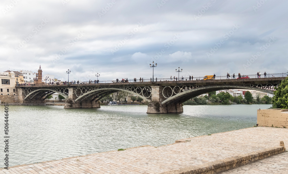 Famous Triana bridge over the Guadalquivir river in Seville (Spain)