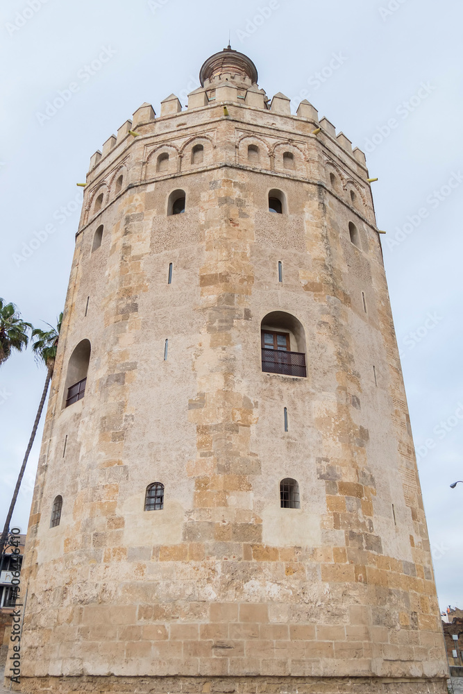 Obraz premium The tourist Torre del Oro in Seville, next to the Guadalquivir river, Andalusia (Spain)