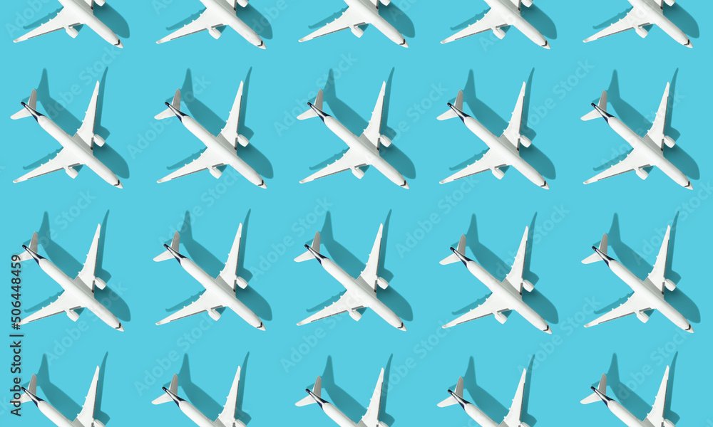 Creative composition made with passenger plane on blue background. Summer travel or vacation pattern. Creative composition made with passenger plane on blue background. Summer travel or vacation pattern.