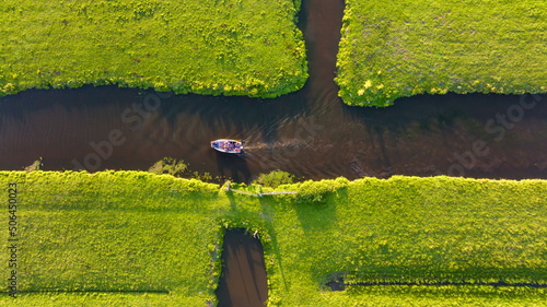 Aerial view of a canal boat in the Netherlands. Canals with water for agricul...