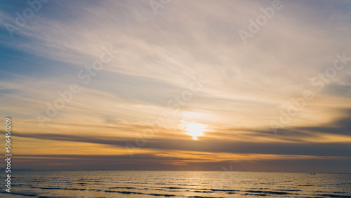 Dusk sky over sea in the evening with orange sunlight