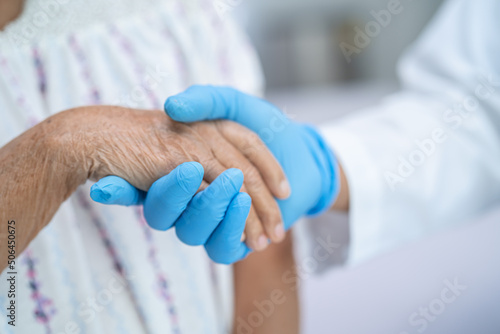 Doctor holding touching hands Asian senior or elderly old lady woman patient with love, care, helping, encourage and empathy at nursing hospital ward, healthy strong medical concept © amazing studio