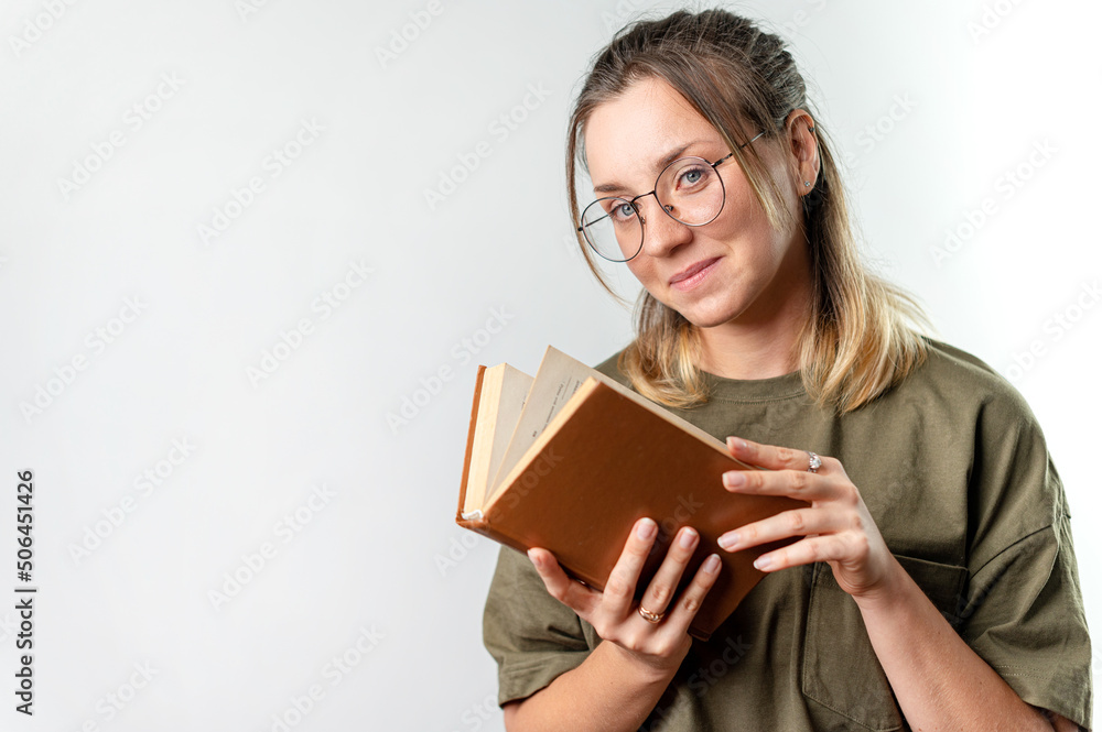 Young happy woman student holding books by her face on white background Young happy woman student holding books by her face on white background