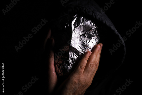 masked man on dark background 