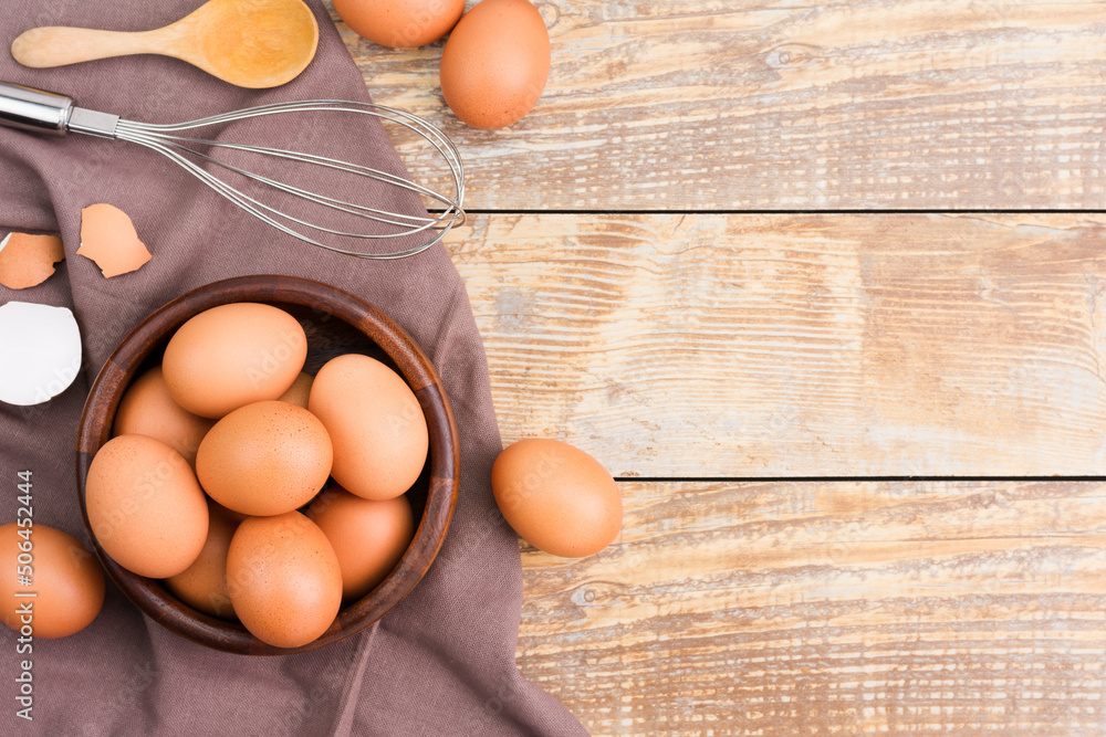 Chicken eggs in a wooden bowl Farm fresh organic eggs laid on a rustic wood Chicken eggs in a wooden bowl Farm fresh organic eggs laid on a rustic wood