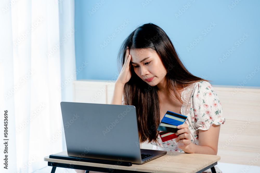 Beautiful Asian girl, very stressed look at online payment that was going to order via laptop computer, but credit card payment failed.online shopping Beautiful Asian girl, very stressed look at online payment that was going to order via laptop computer, but credit card payment failed.online shopping