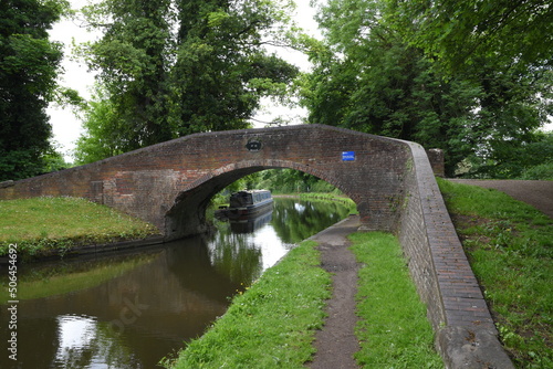 the arch bridge that goes over the canal in Stourton with a canal boat on the side of the canal