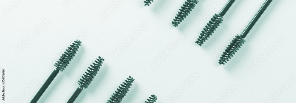 Black brushes and applicators for eyelashes and eyebrows on blue background. Womens cosmetics. Makeup for the face. Black brushes and applicators for eyelashes and eyebrows on blue background. Womens cosmetics. Makeup for the face.