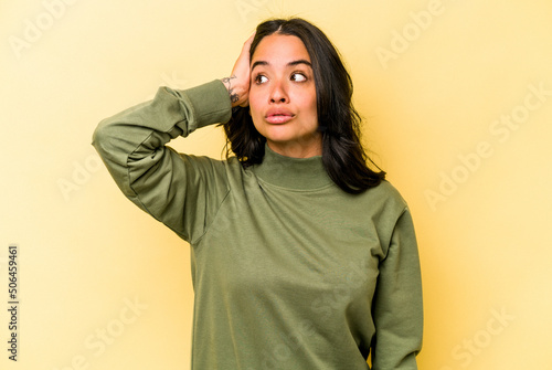 Young hispanic woman isolated on yellow background being shocked, she has remembered important meeting. © Asier