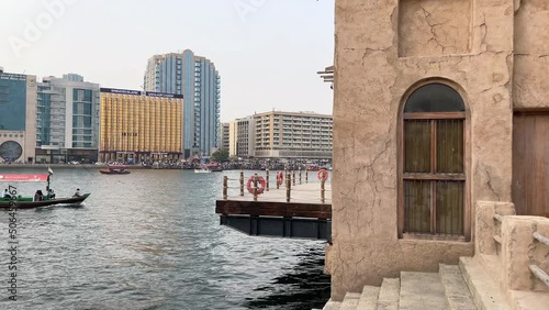 Dubai creek, the old and historic side of Dubai city - Old Arabian buildings and boats - Al Seef District, outdoor shopping and restaurants photo