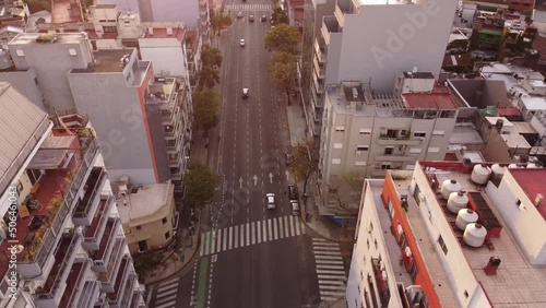 Cars driving along Cordoba avenue in Buenos Aires city at sunset, Argentina. Aerial drone static view photo