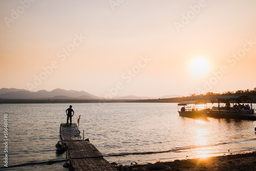 Boy Standing on dock at sunset in mexico