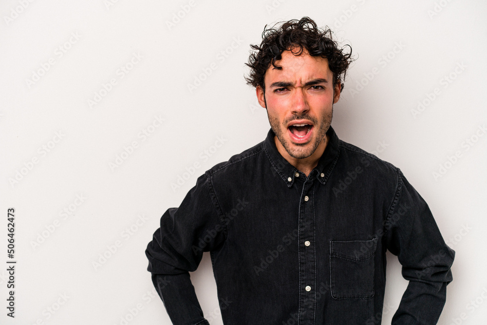 Young caucasian man isolated on white background shouting very angry, rage concept, frustrated.
