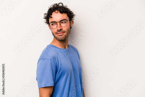 Wallpaper Mural Young caucasian man isolated on white background looks aside smiling, cheerful and pleasant. Torontodigital.ca