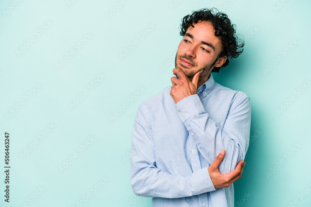 Young caucasian man isolated on white background looking sideways with doubtful and skeptical expression. Young caucasian man isolated on white background looking sideways with doubtful and skeptical expression.