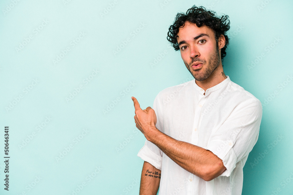 Young caucasian man isolated on white background smiling and pointing aside, showing something at blank space. Young caucasian man isolated on white background smiling and pointing aside, showing something at blank space.