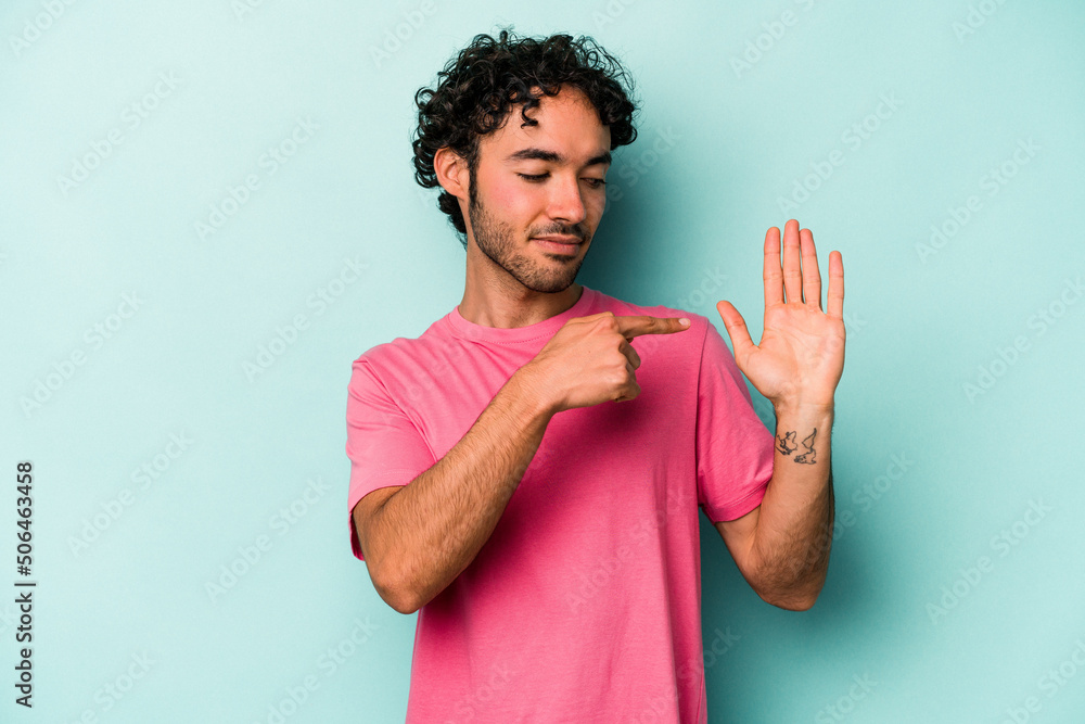 Young caucasian man isolated on white background smiling cheerful showing number five with fingers. Young caucasian man isolated on white background smiling cheerful showing number five with fingers.