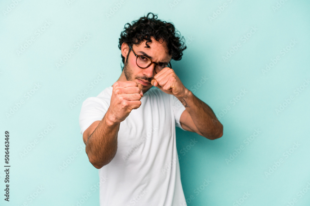 Young caucasian man isolated on white background throwing a punch, anger, fighting due to an argument, boxing.