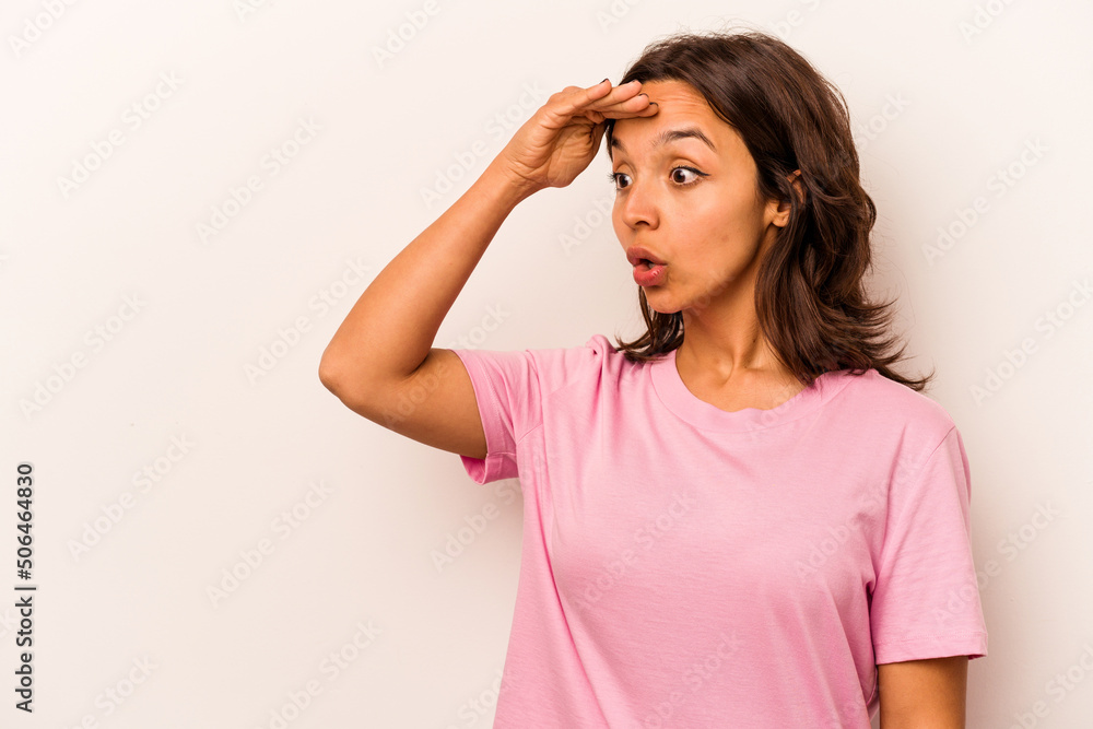 Young hispanic woman isolated on white background looking far away keeping hand on forehead. Young hispanic woman isolated on white background looking far away keeping hand on forehead.
