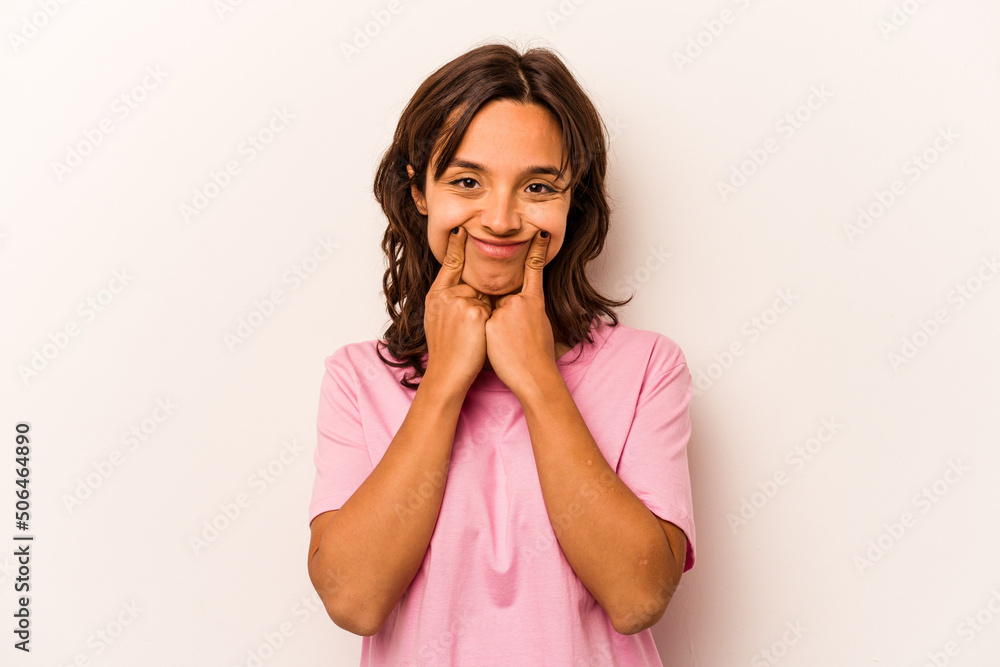 Young hispanic woman isolated on white background doubting between two options. Young hispanic woman isolated on white background doubting between two options.
