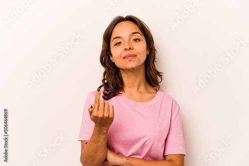 Young hispanic woman isolated on white background pointing with finger at you as if inviting come closer.