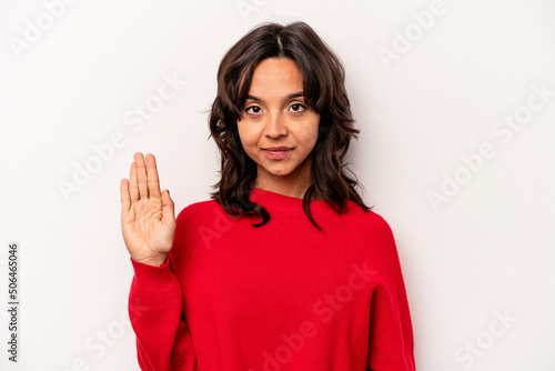 Young hispanic woman isolated on white background smiling cheerful showing number five with fingers. © Asier