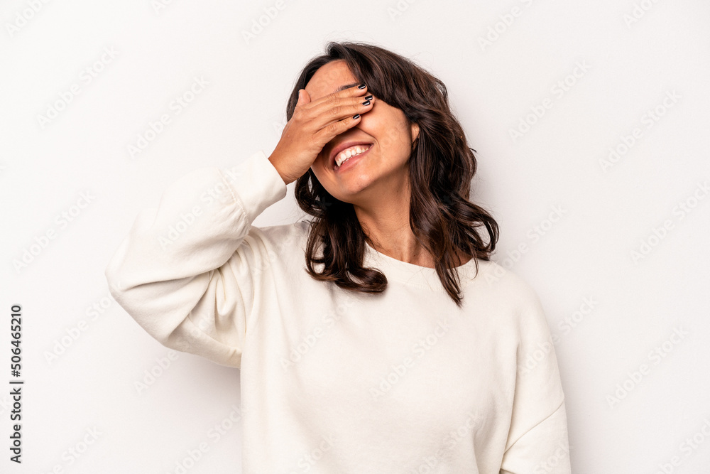 Young hispanic woman isolated on white background laughs joyfully keeping hands on head. Happiness concept. Young hispanic woman isolated on white background laughs joyfully keeping hands on head. Happiness concept.
