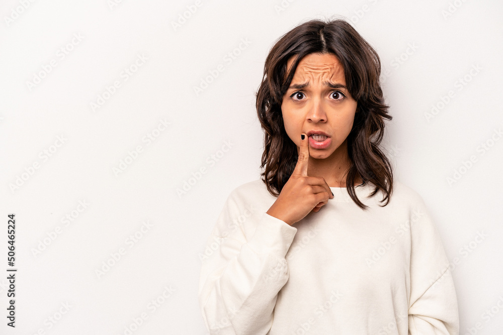Young hispanic woman isolated on white background looking sideways with doubtful and skeptical expression. Young hispanic woman isolated on white background looking sideways with doubtful and skeptical expression.