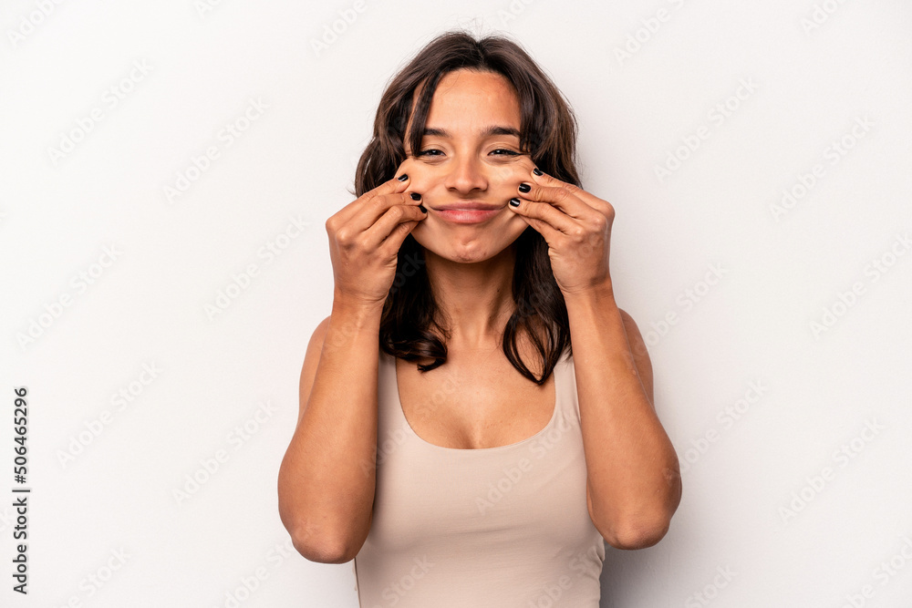 Young hispanic woman isolated on white background doubting between two options. Young hispanic woman isolated on white background doubting between two options.